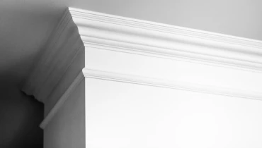 White crown molding wrapping around the corner of a wall