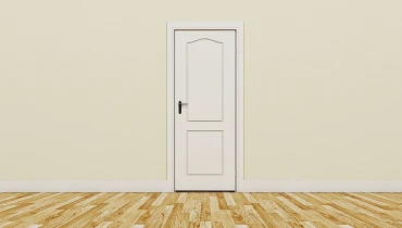 White door in an off-white wall with wooden flooring below