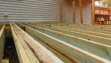 A deck that has had its boards removed during an appointment for deck repairs.