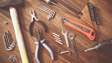 A collection of hand tools and small parts that would be used by a handyman in Summerville, SC.