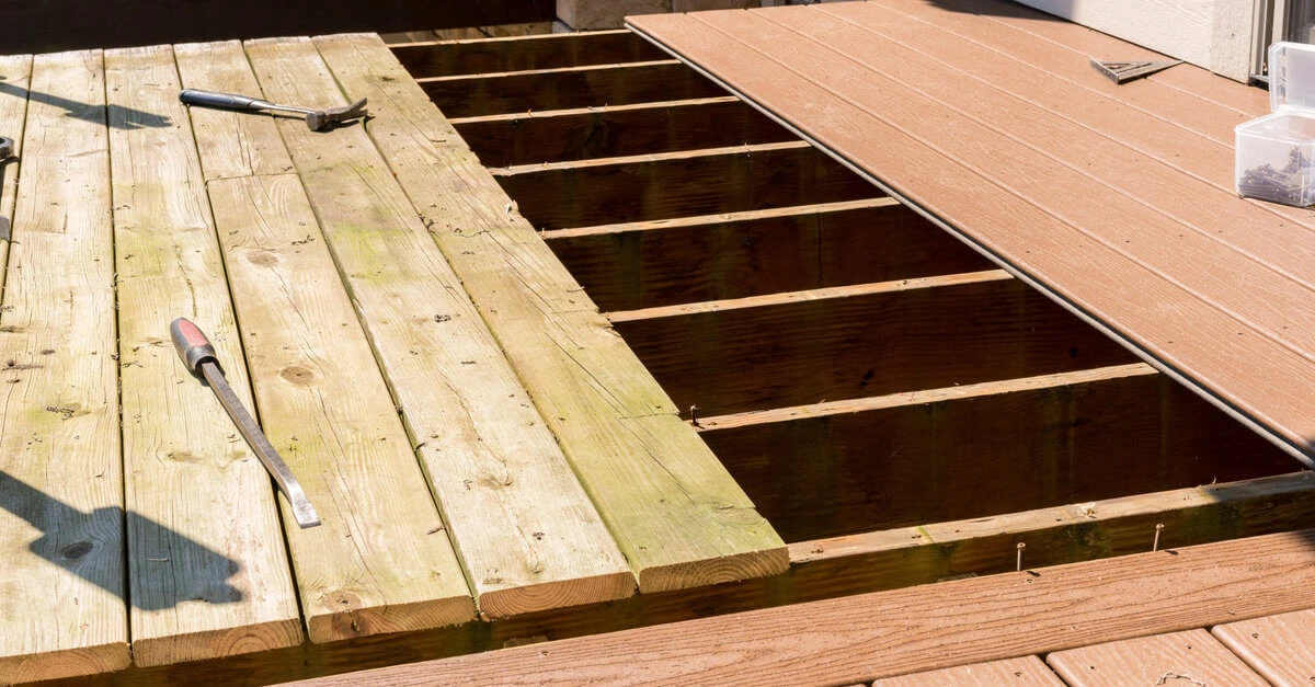 A deck with boards that have been removed and new boards that have been added during an appointment for Charleston deck repair.