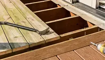 A deck with missing boards that are in the process of being replaced during an appointment for deck repair.