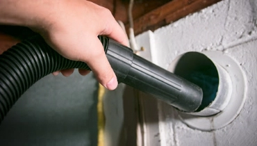 dryer vent cleaning in progress at a residential home