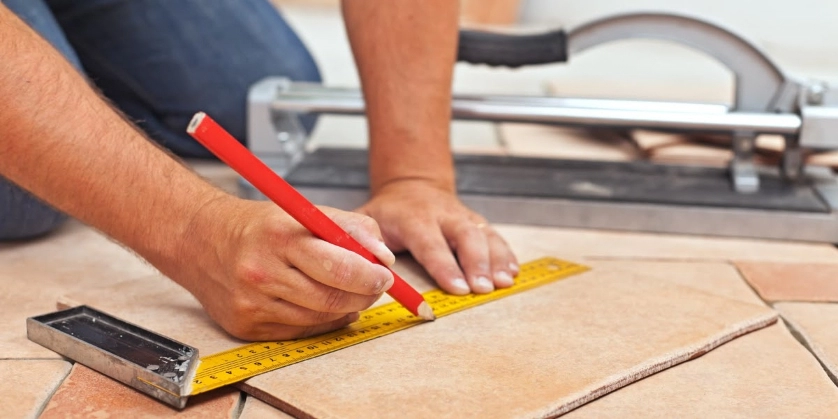 Floor tile repairs being rendered by a handyman