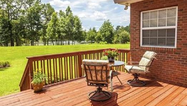 wood deck with chairs and brick home