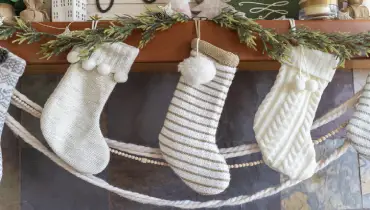 Christmas stockings hanging from a fireplace