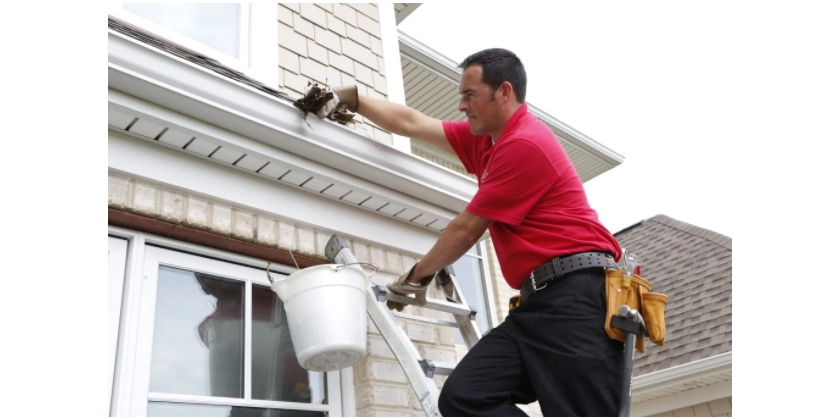 Mr. Handyman service professional performing gutter cleaning services