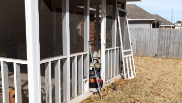 Screen door replacement and other professional porch services being completed with the help of a local handyman.