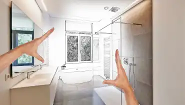 A homeowner holding up their hands to visualize the results of their new bathroom remodel.
