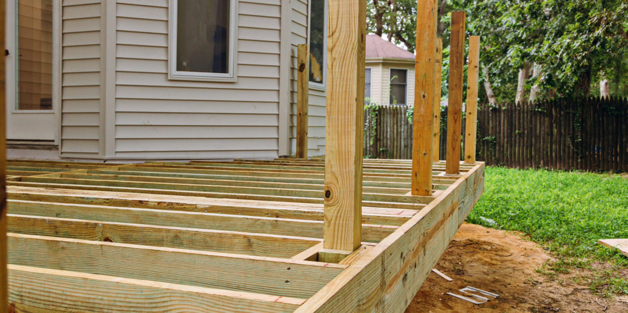 The exposed structure of a porch that is having its rail and boards replaced during an appointment for porch repair.