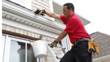 Mr. Handyman service professional performing gutter cleaning services.