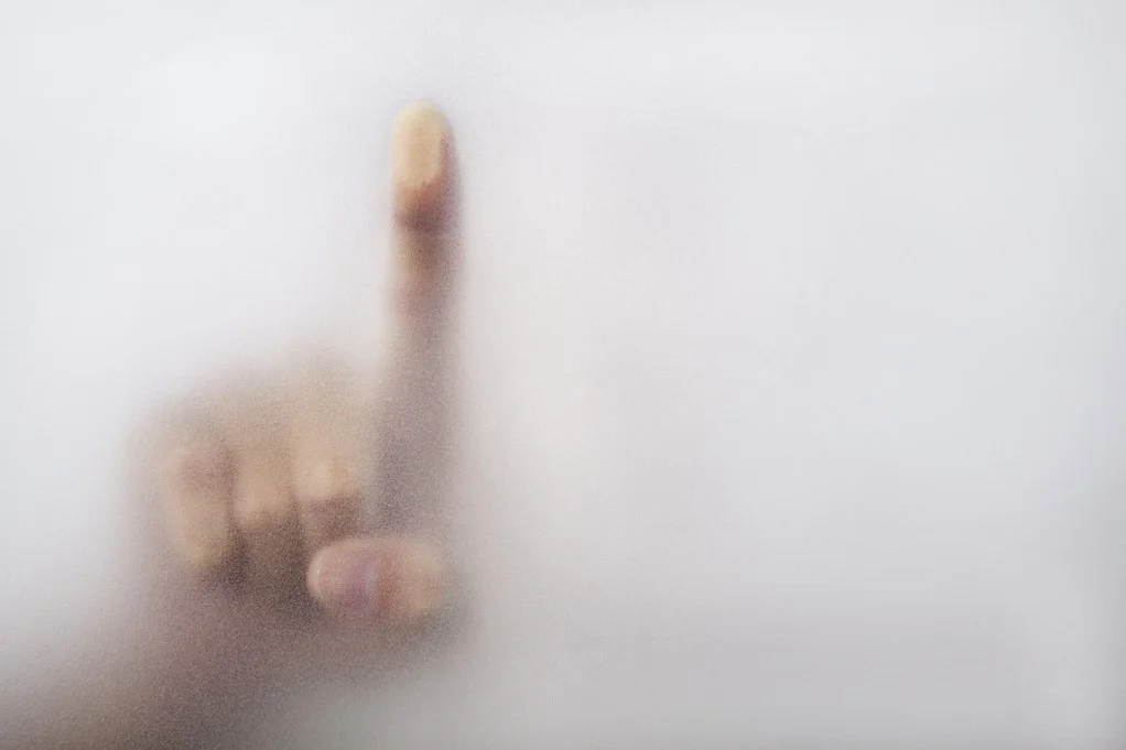 Photo of a finger on fogged glass