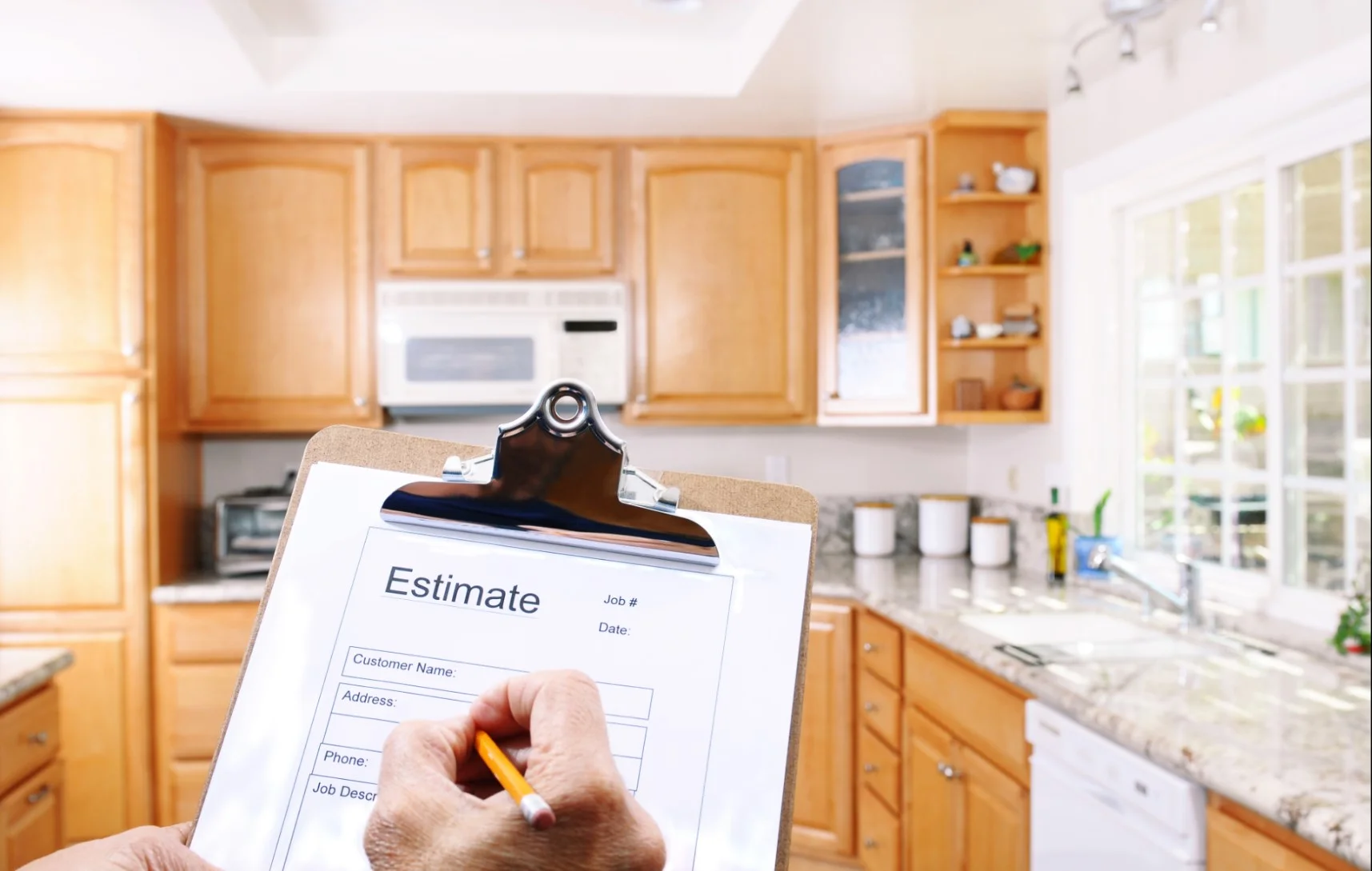 Photo of someone taking an estimate of a kitchen
