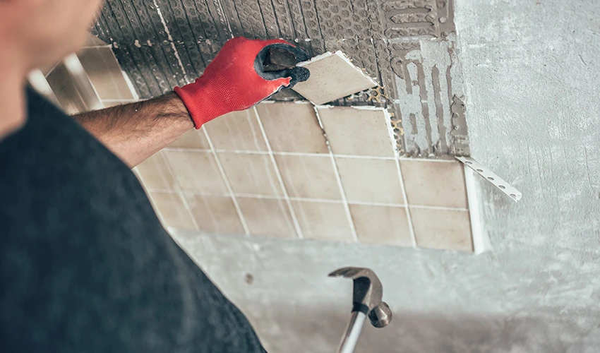 man laying down tile