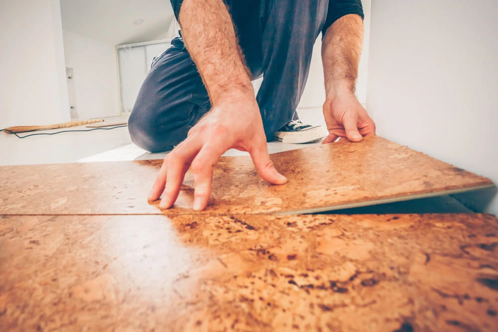 Man installing cork flooring.