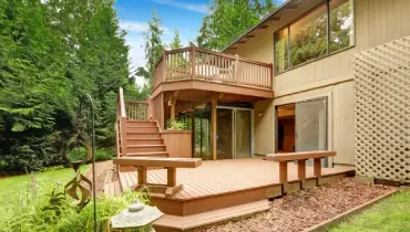 A two-story deck at the back of a house.