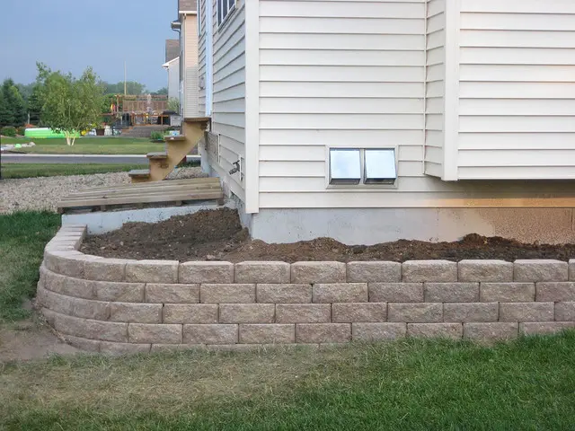 stone retaining wall surrounding house