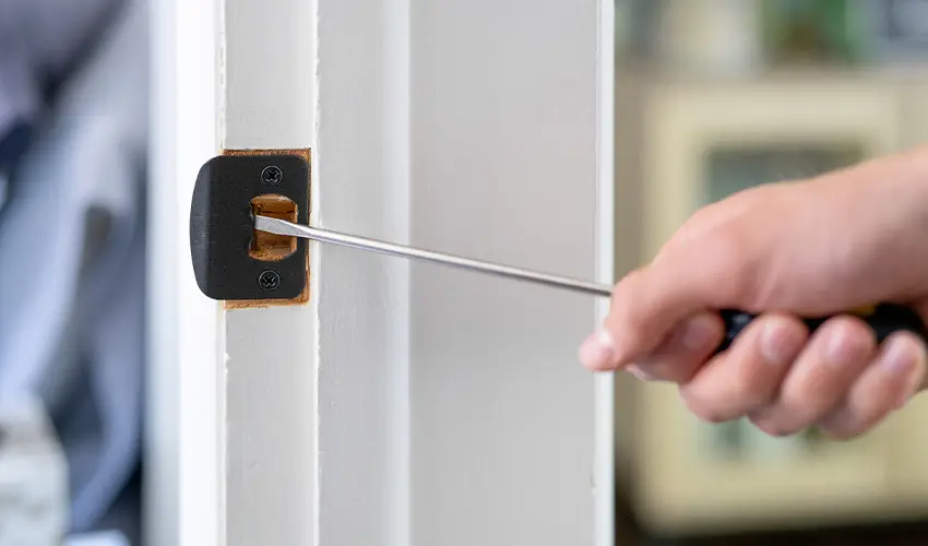 Fixing a loose door latch.