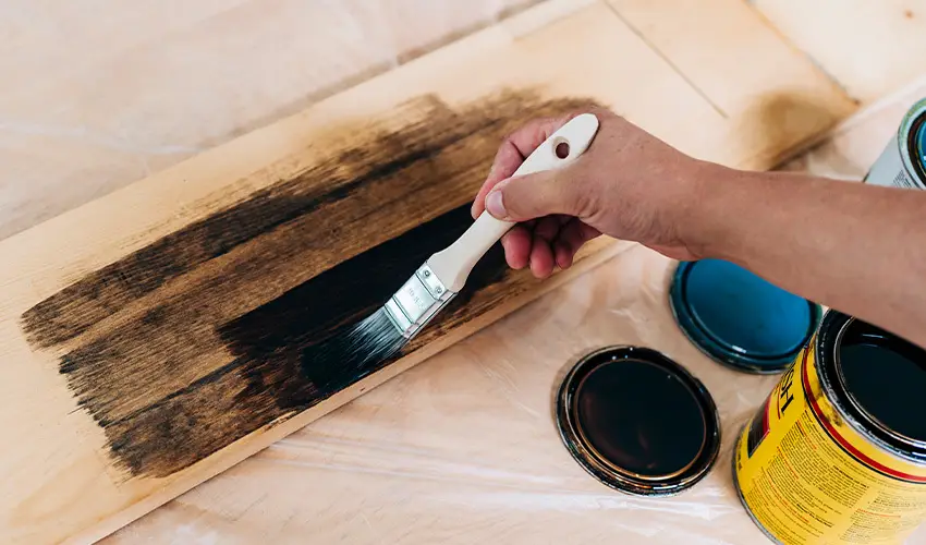 Painting a wooden panel. 