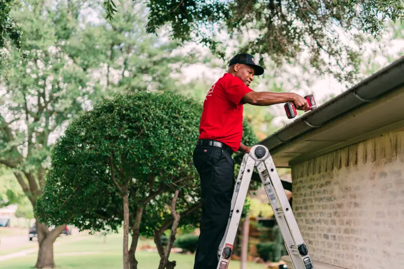 Man cleaning rain gutters