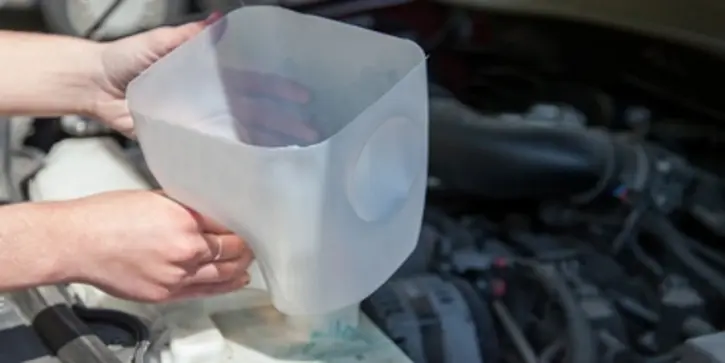 Hands holding a plastic funnel