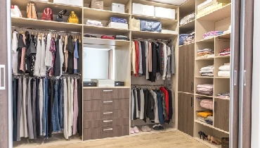 Well organized walk-in closet in a residential home.
