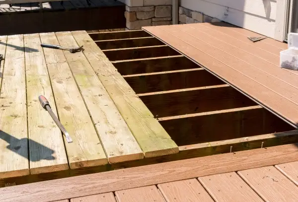 Repair and replacement of an old wooden deck or patio with modern composite plastic material.