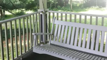 Porch swing on a porch.