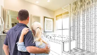 Couple looking at an illustrated rendition of a bathroom remodel