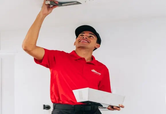  handyman performing drywall repair on the ceiling,