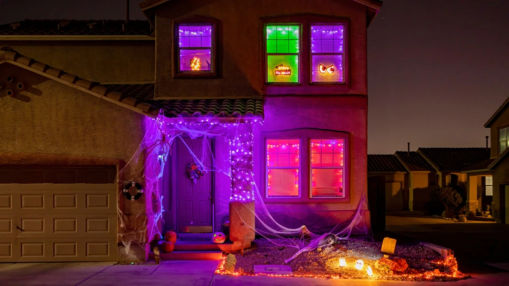 DIY spooky fun halloween lighting on home exterior.
