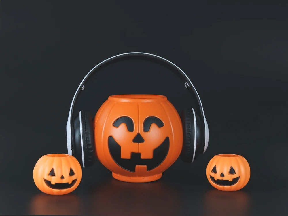 Plastic Halloween Jack-o-Laterns with over ear headsets.