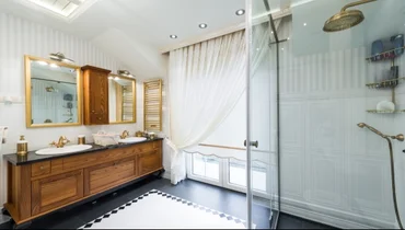 White bathroom with a glass shower door.