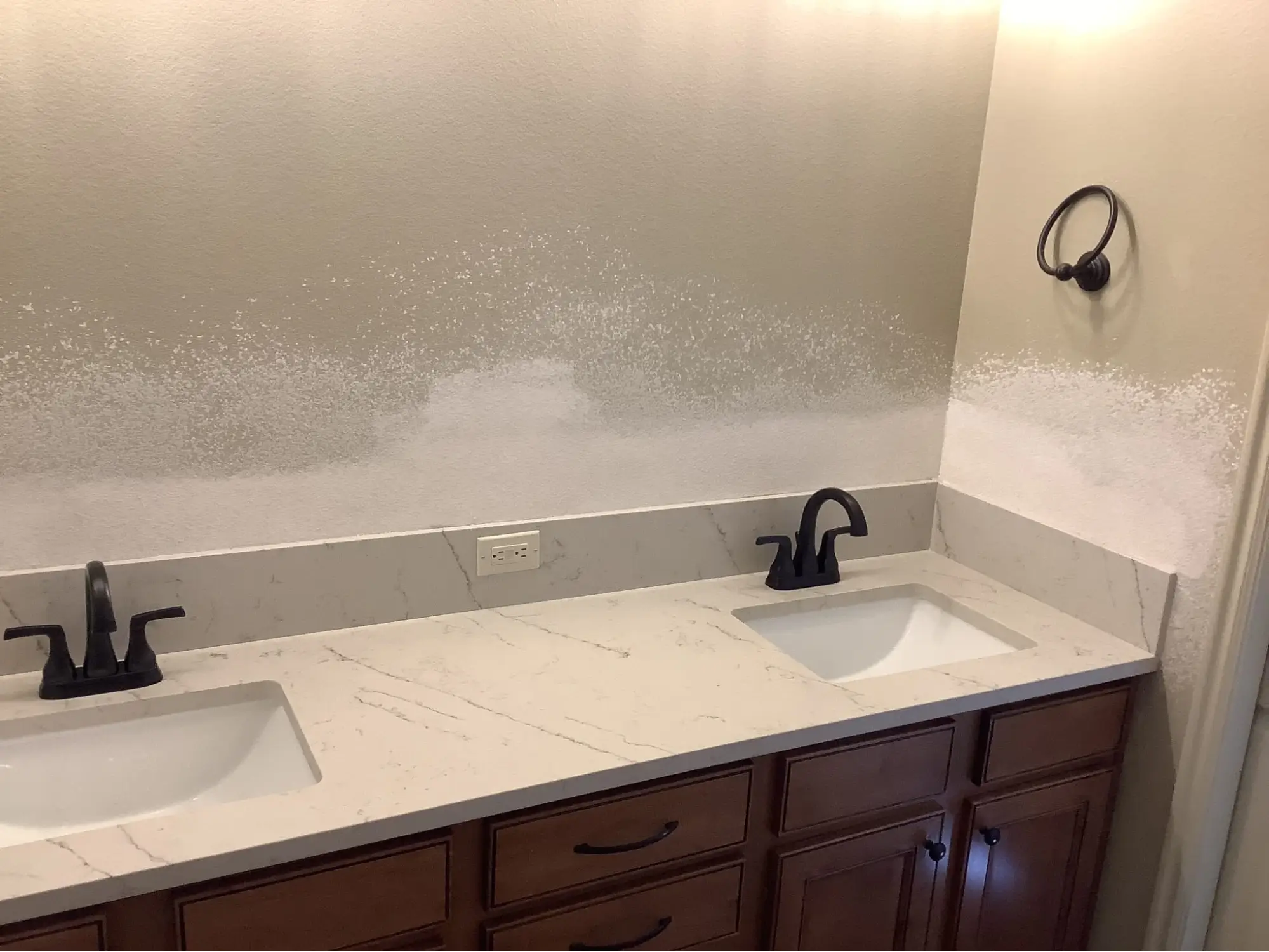 A client testimonial photo of drywall repair in a bathroom.