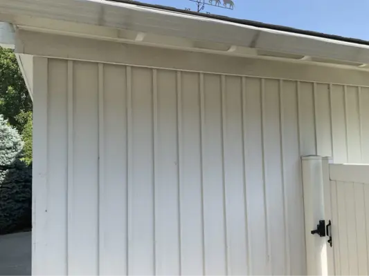 A client testimonial image of pressure-washed white siding on a house.