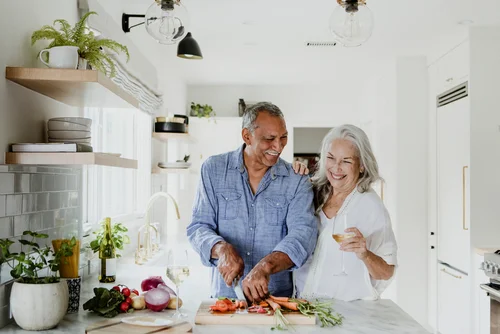 Senior couple cooking together in the kitchen.