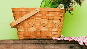 basket sitting on a table in front of a green wall