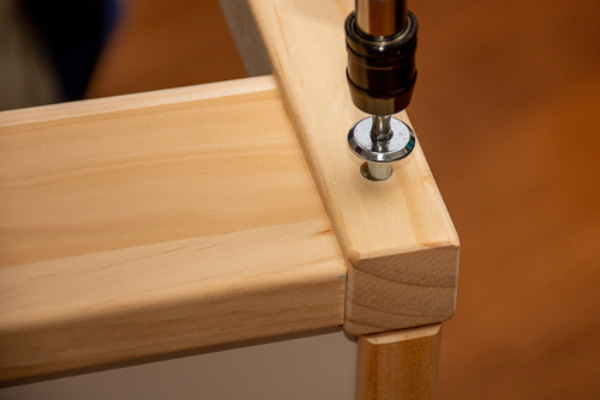 Professional handyman providing IKEA furniture assembly service with tools.