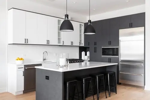 A modern kitchen with black and white cabinets
