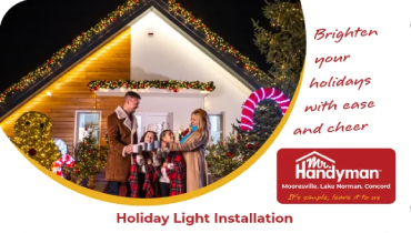 Family standing outside a house decorated with holiday lights.