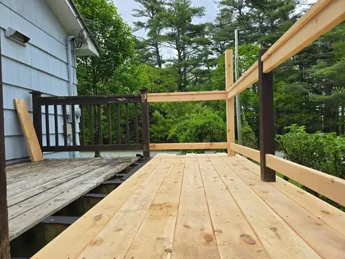 Deck repair; replacing rotted wood deck boards.