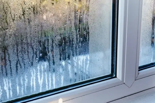 Close-up of window with insulation keeping out the rain.