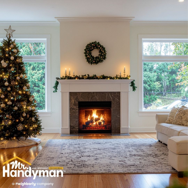 A cozy living room featuring a decorated Christmas tree beside a warm fireplace.
