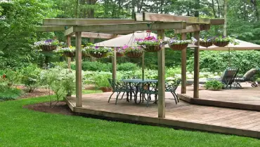 Outdoor floating deck with elaborate green furniture.