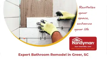 Worker installing white ceramic wall tiles.