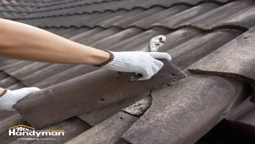 A person in a white glove uses pliers to adjust a roof tile.