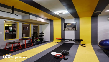 Home gym with striped yellow and gray walls.