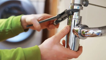 Handyman inspecting water heater.