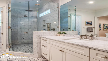 Modern bright bathroom with marble countertop.