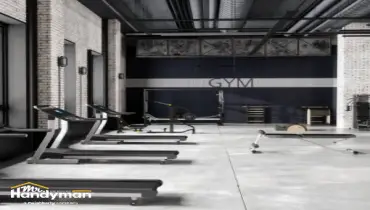 Mr. Handyman technician servicing commercial door hardware and locks at a South Bend Northern Indiana fitness facility